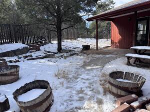 snow covered patio featuring a fire pit