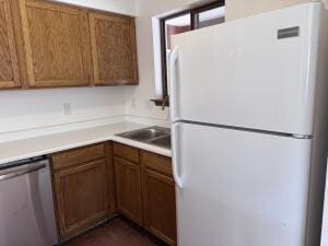 kitchen with white refrigerator and stainless steel dishwasher