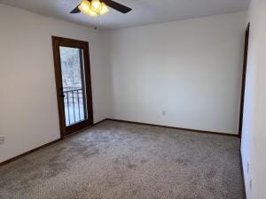 spare room with carpet and ceiling fan