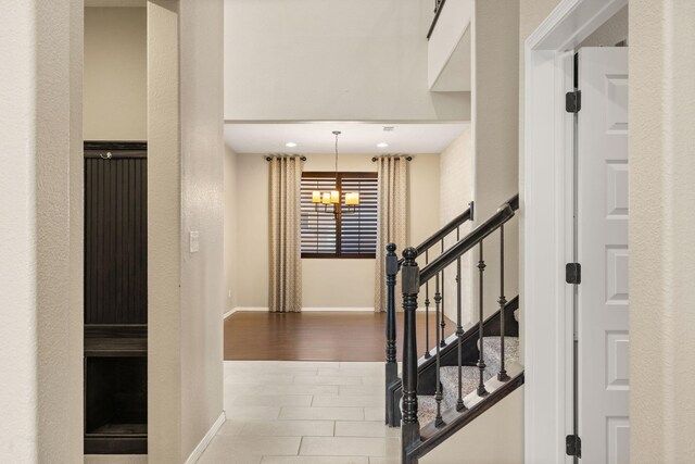 interior space with a notable chandelier and hardwood / wood-style floors