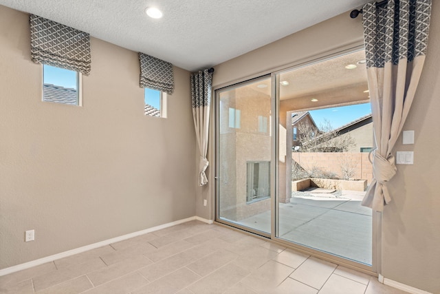 doorway to outside with a textured ceiling