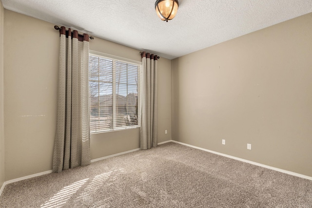 unfurnished room featuring a textured ceiling and carpet