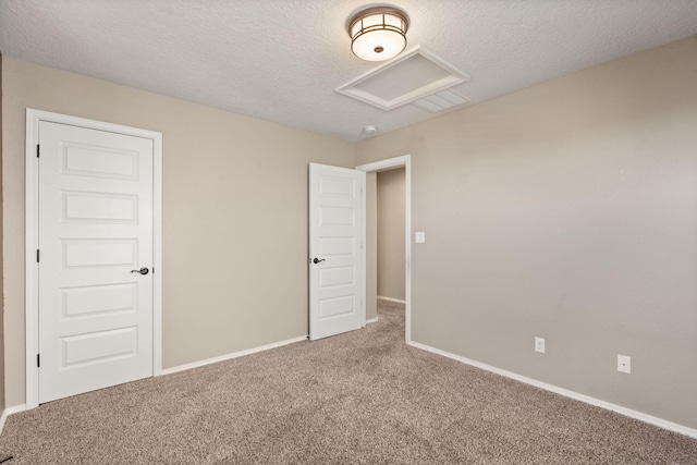 spare room with a textured ceiling and carpet