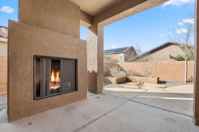 view of patio / terrace with an outdoor fireplace