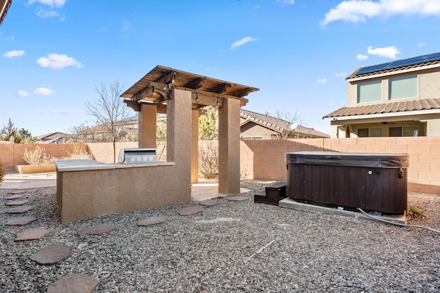 view of yard featuring exterior kitchen and a hot tub