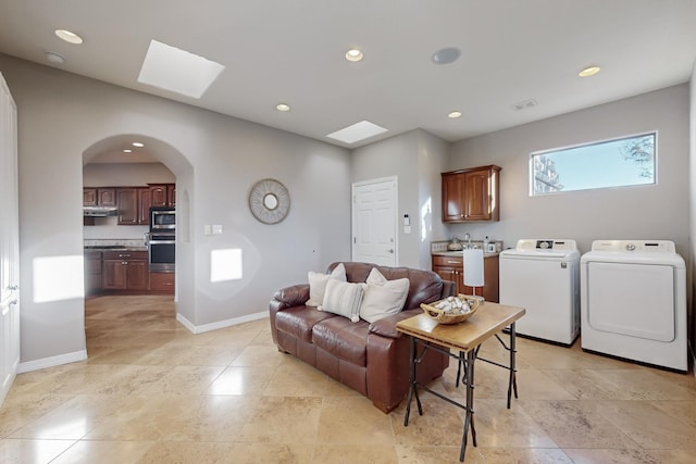 living room with a skylight and separate washer and dryer