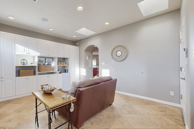 living room featuring a skylight