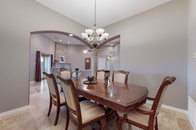 dining room with a notable chandelier and a fireplace