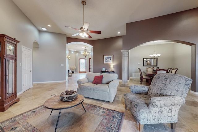 living room with ceiling fan with notable chandelier and ornate columns