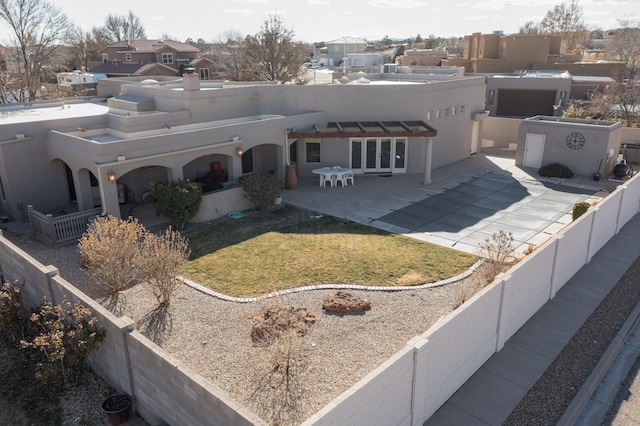 back of property featuring a yard and a patio