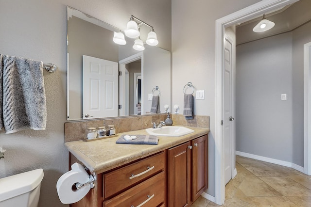 bathroom with toilet and vanity