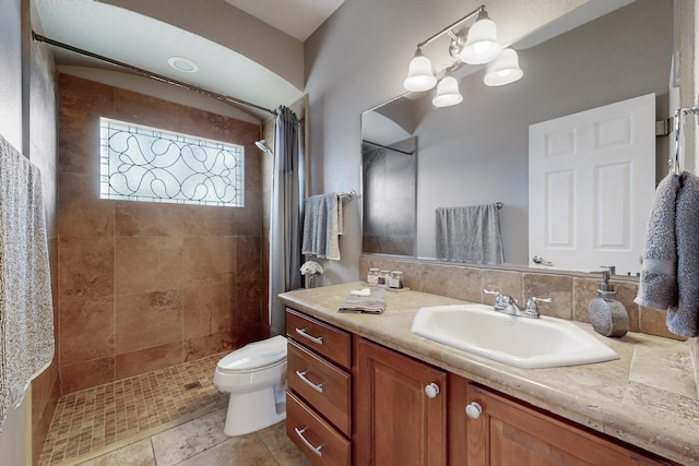 bathroom with toilet, vanity, backsplash, and curtained shower