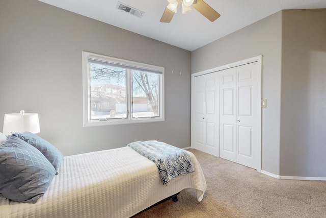 bedroom featuring ceiling fan, carpet, and a closet