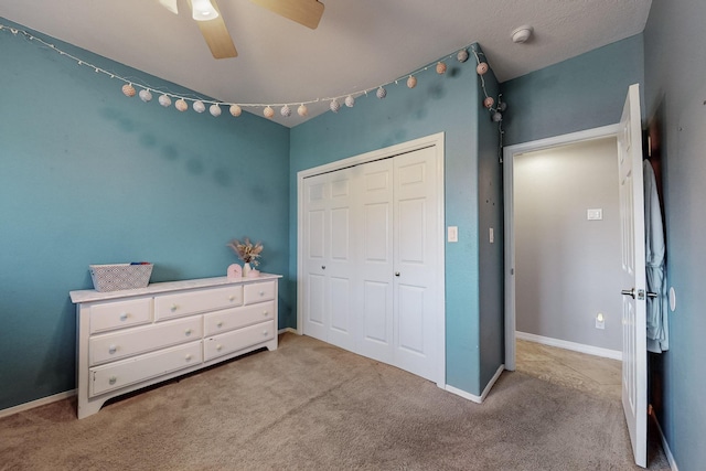 carpeted bedroom featuring a closet and ceiling fan