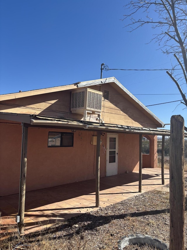 back of house with central air condition unit and a patio