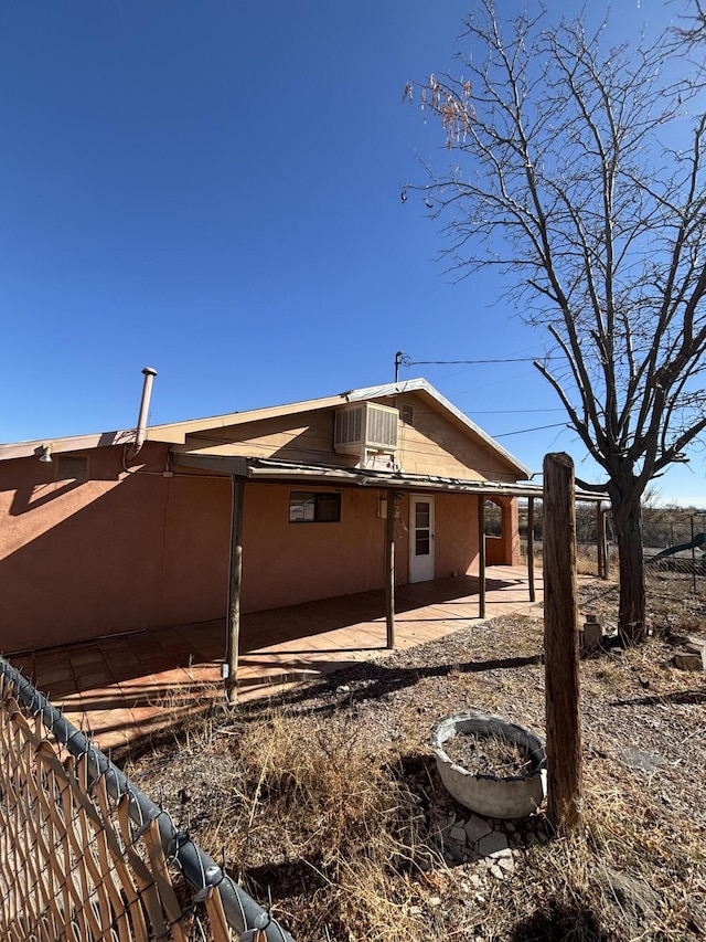 view of property exterior featuring central air condition unit and a patio