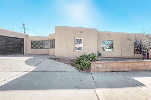 southwest-style home featuring a garage