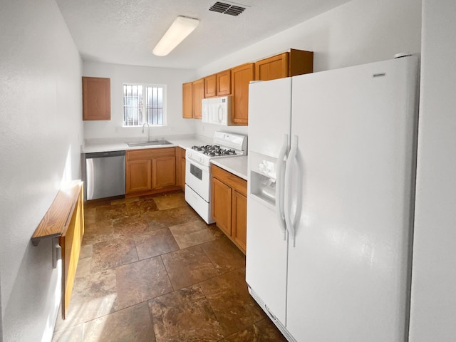 kitchen featuring sink and white appliances