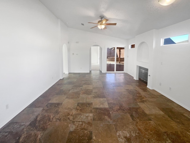 unfurnished living room with vaulted ceiling and ceiling fan