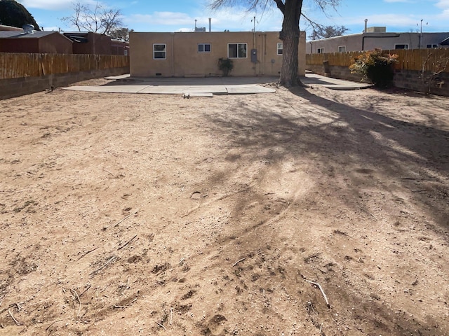 back of house featuring a patio area, fence, and stucco siding