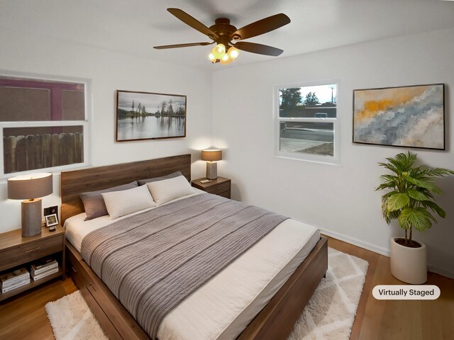 bedroom with ceiling fan and wood finished floors