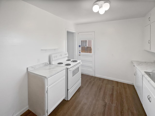 kitchen with electric range, baseboards, white cabinets, dark wood finished floors, and light countertops