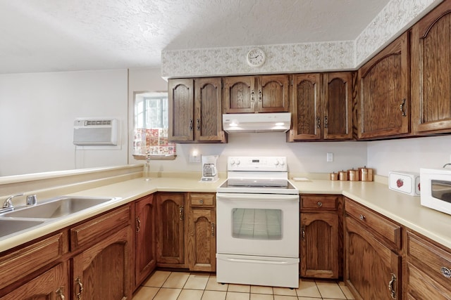 kitchen featuring a wall unit AC, white appliances, light tile patterned flooring, a textured ceiling, and sink