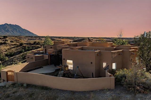 aerial view at dusk featuring a mountain view