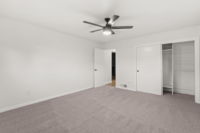 unfurnished bedroom featuring carpet flooring, ceiling fan, and a closet