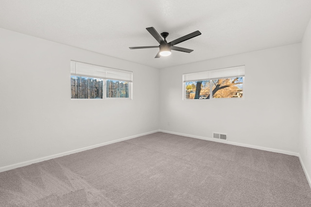 unfurnished room featuring ceiling fan and carpet