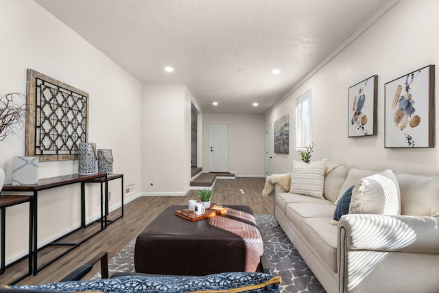 living room with dark hardwood / wood-style floors and a textured ceiling