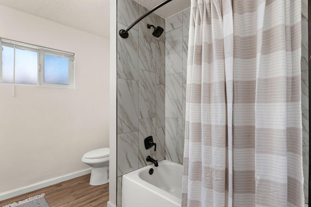 bathroom featuring shower / tub combo with curtain, wood-type flooring, toilet, and a textured ceiling