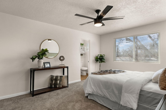 carpeted bedroom featuring ensuite bath, a textured ceiling, and ceiling fan