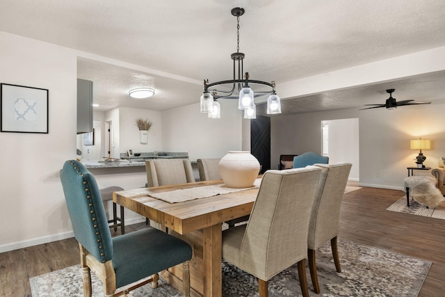 dining space featuring ceiling fan, dark hardwood / wood-style floors, and a textured ceiling