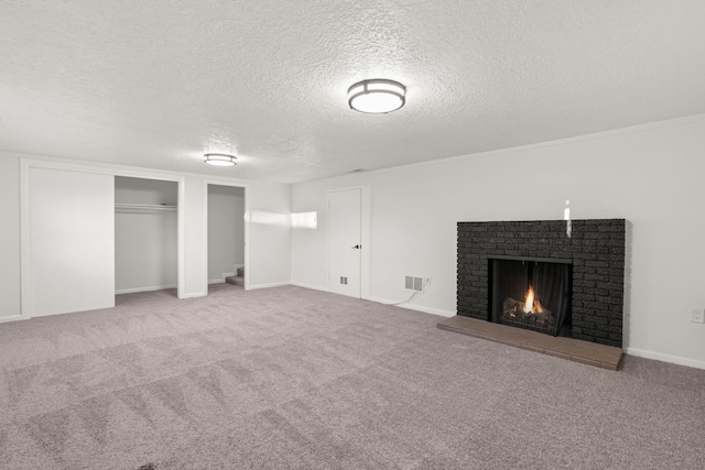 basement with a fireplace, carpet floors, and a textured ceiling