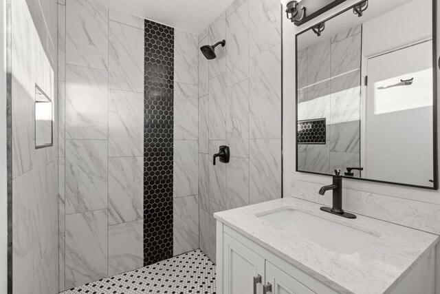 bathroom featuring vanity and a tile shower