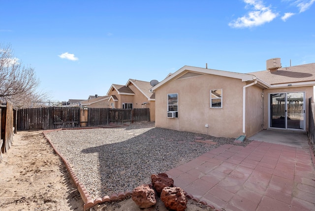 back of property featuring cooling unit and a patio