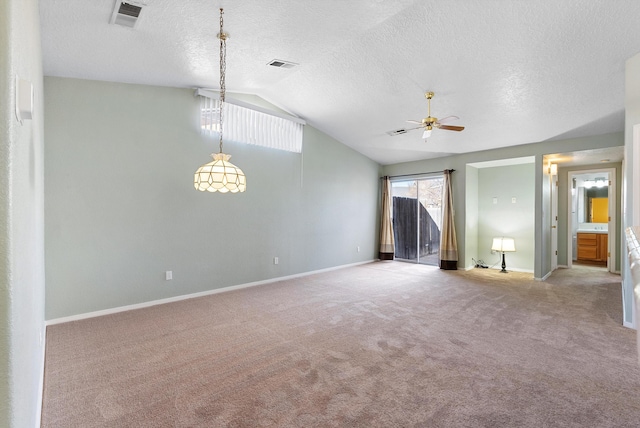 interior space featuring ceiling fan, light colored carpet, vaulted ceiling, and a textured ceiling