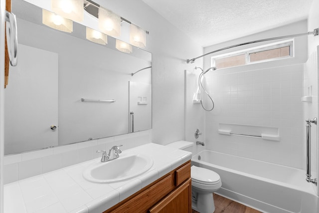 full bathroom featuring toilet, vanity, hardwood / wood-style flooring, a textured ceiling, and shower / tub combination