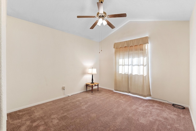 carpeted spare room with ceiling fan and lofted ceiling