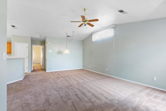 carpeted spare room featuring ceiling fan and lofted ceiling