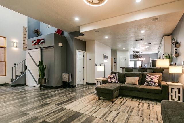 living room featuring wood-type flooring and a chandelier