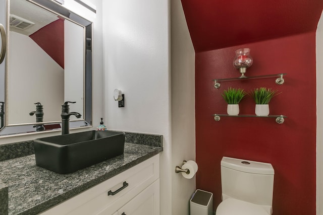 bathroom with toilet and vanity