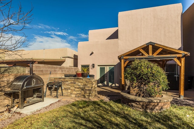 exterior space with a gazebo, exterior kitchen, an outdoor bar, and grilling area