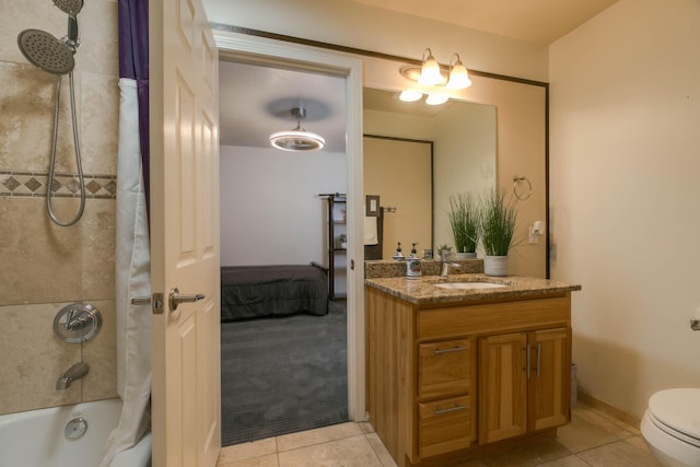 full bathroom featuring toilet, tiled shower / bath combo, tile patterned floors, and vanity