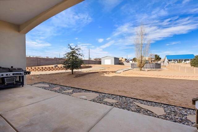 view of patio featuring a grill and a storage shed