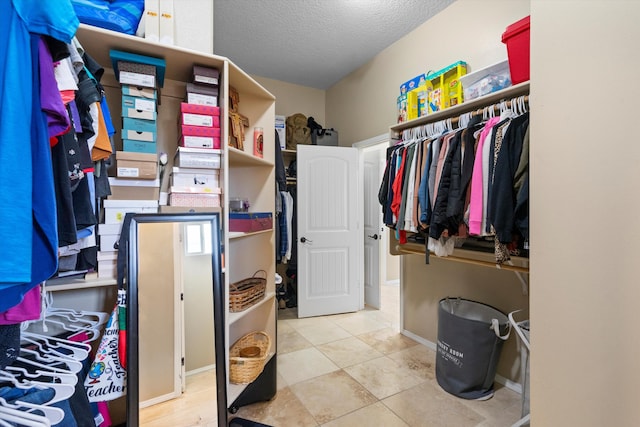 walk in closet with tile patterned floors