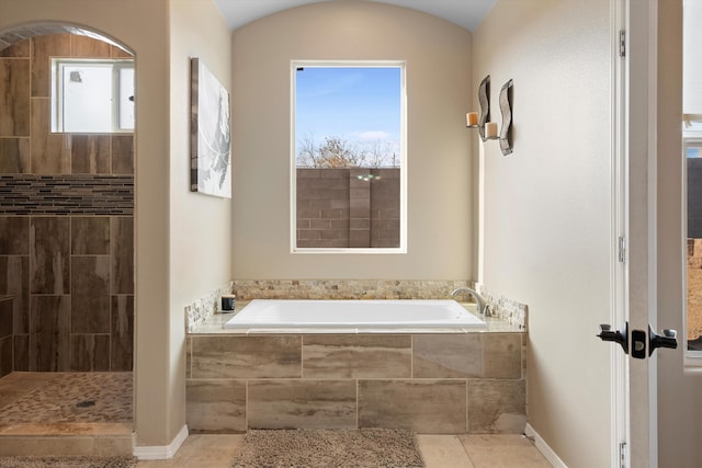 bathroom with plenty of natural light, separate shower and tub, and tile patterned flooring