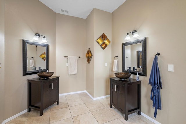 bathroom featuring two vanities, a sink, visible vents, and tile patterned floors