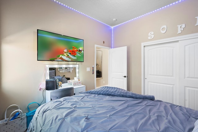 bedroom with a textured ceiling and a closet